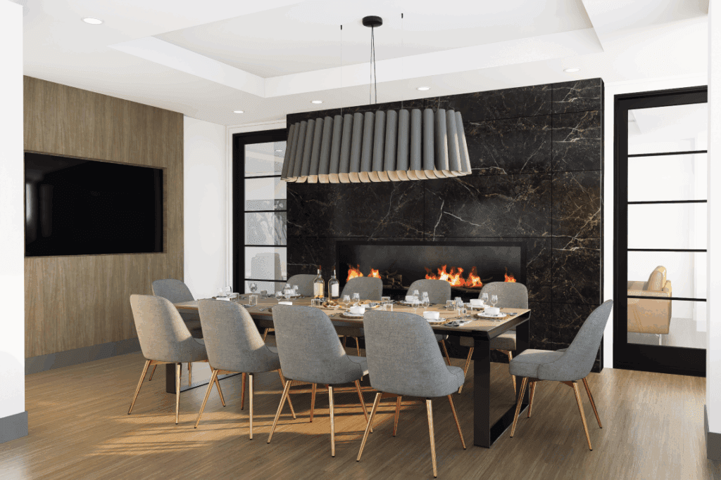 A room featuring a table and chairs, with a vase on the table. The space includes a floor, walls, and a ceiling, indicative of indoor furniture design suitable for a dining or living room.