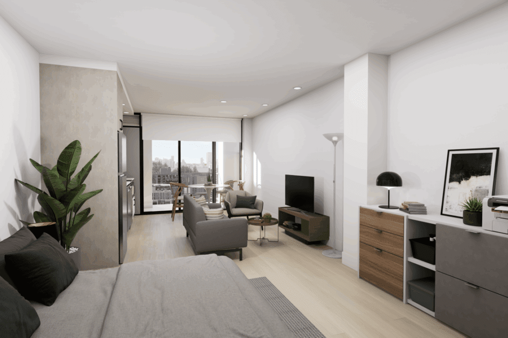 A cozy bedroom featuring a bed with decorative bedding and pillows, a nightstand beside it, and a desk against the wall. There are cabinetry and a chest of drawers in the room, along with a television mounted on the wall.