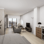A cozy bedroom featuring a bed with decorative bedding and pillows, a nightstand beside it, and a desk against the wall. There are cabinetry and a chest of drawers in the room, along with a television mounted on the wall.