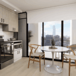 A kitchen featuring a table and chairs, equipped with various home appliances including a sink and oven. The room has cabinetry, countertops, and a floor, all contributing to the overall interior design.