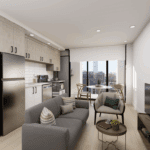 A cozy living room featuring a comfortable couch facing a television, with cabinetry and decorative elements adorning the walls. The floor is well-maintained, and the overall ambiance reflects modern interior design.
