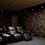 Five leather recliners in a spacious movie theater room with a large smart TV.