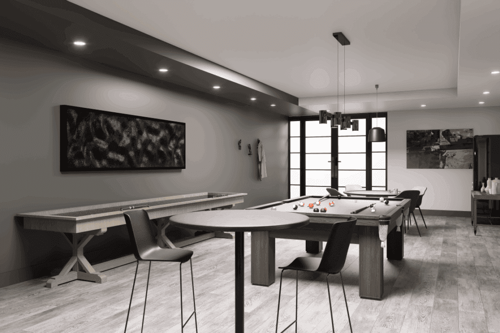 A games room featuring a ping pong table, pool table, and shuffleboard, with lots of tables and seating to play board games or poker