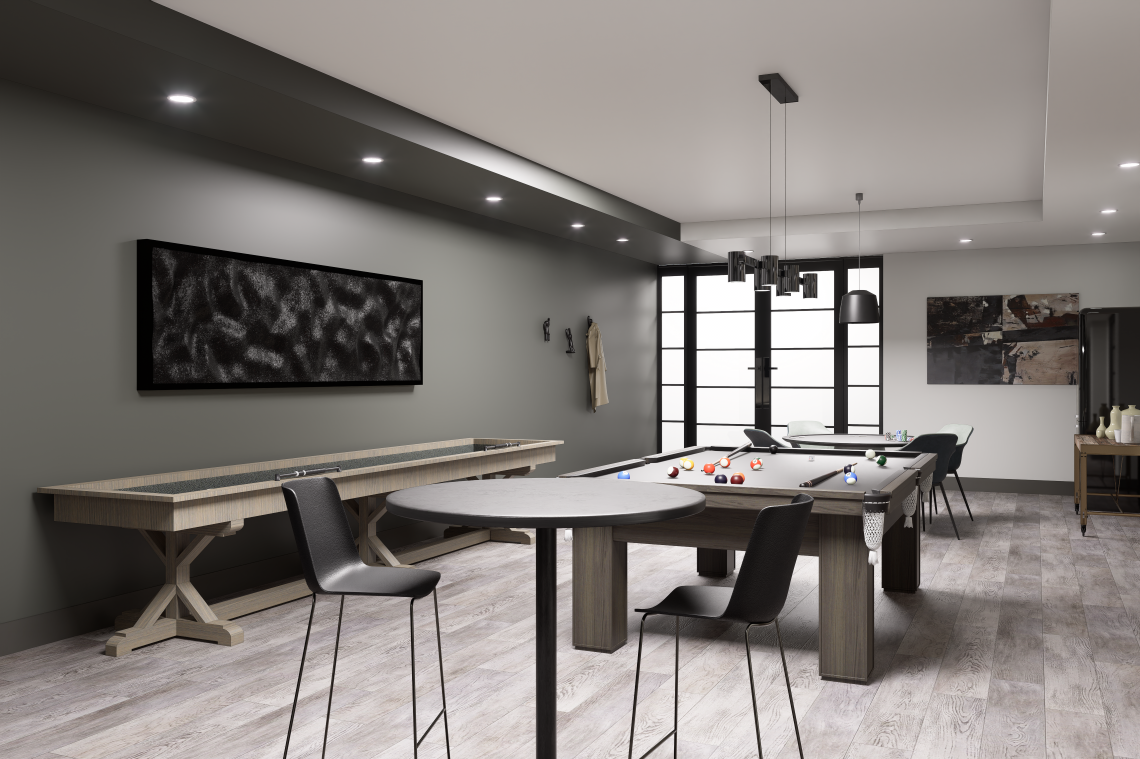 A games room featuring a ping pong table, pool table, and shuffleboard, with lots of tables and seating to play board games or poker