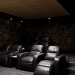 Five leather recliners in a spacious movie theater room with a large smart TV.